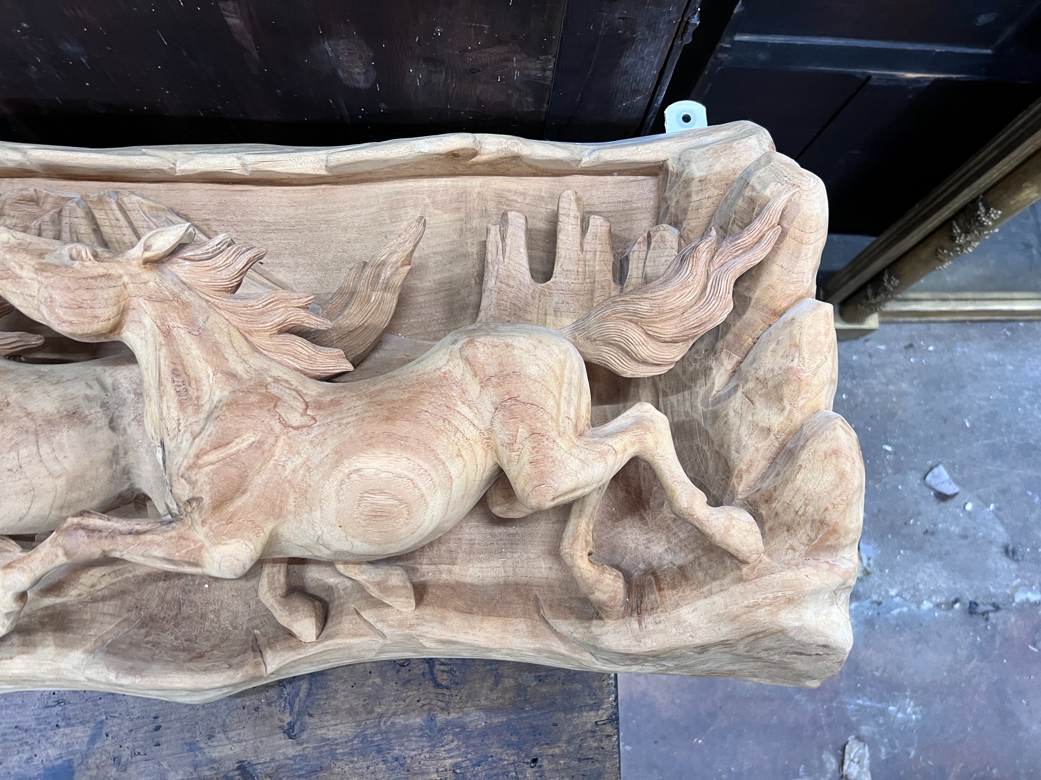 An unusual, probably American, carved wood panorama of eight galloping horses, width 200cm, height 46cm *Please note the sale commences at 9am.